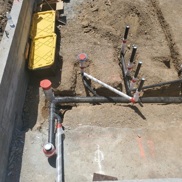 New building, drain pipes installed before foundation and in trenches